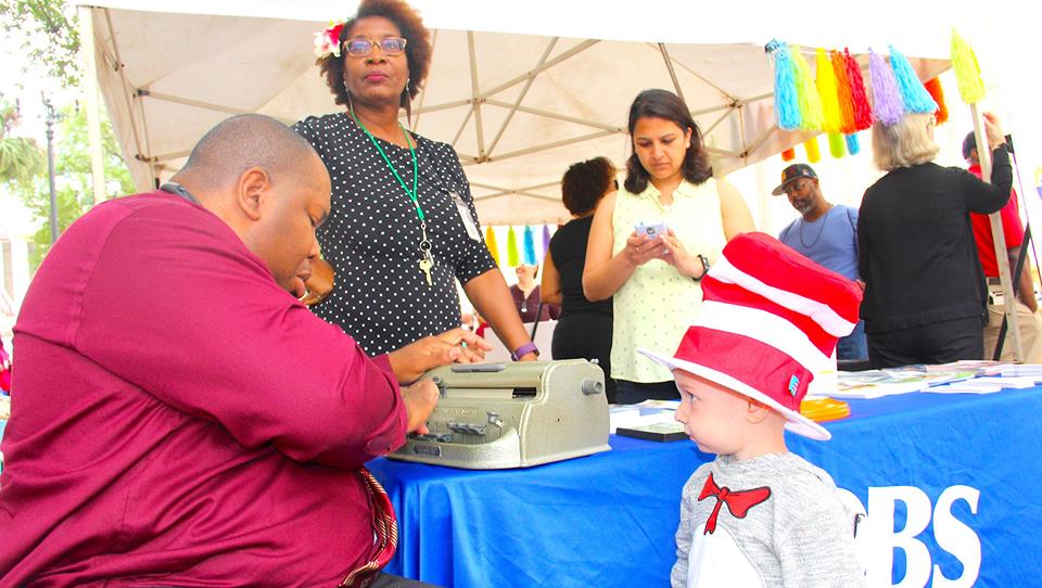 DBS staff member Walter Blackmon uses the Perkins Brailler to braille a young child’s name.